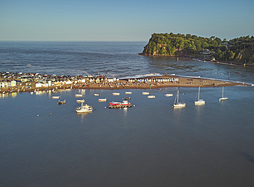 An evening view across the harbour and sandbar in the mouth of the River Teign, looking towards the Ness headland, Teignmouth, on the south coast of Devon, England, United Kingdom, Europe