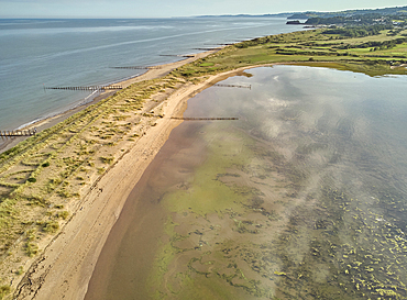 Aerial view of beach and dunes at Dawlish Warren, guarding the mouth of the River Exe, looking south along the coast towards the town of Dawlish, Devon, England, United Kingdom, Europe