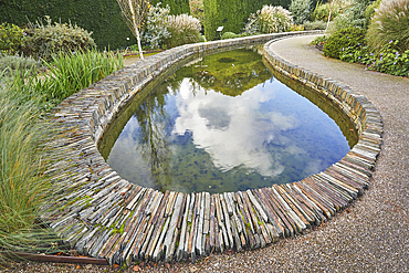 A formal garden scene, with pond, in Devon, England, United Kingdom, Europe