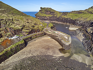 An aerial view of the narrow harbour and surrounding cliffs at Boscastle, on the Atlantic coast of north Cornwall, England, United Kingdom, Europe