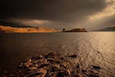 Winter sun lights Ardvreck Castle, Loch Assynt, Scotland, United Kingdom, Europe