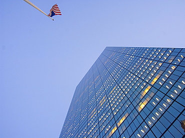 Looking up at Boston skyscraper and USA flag, Boston, Massachusetts, New England, United States of America, North America