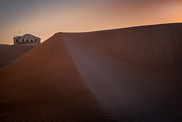 Old house amongst the sand dunes in the ghost town of Kolmanskop, Namibia, Africa