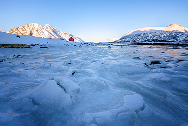 Rorbuer (fisherman's hut) on a frozen lake, Lofoten, Nordland, Arctic, Norway, Europe