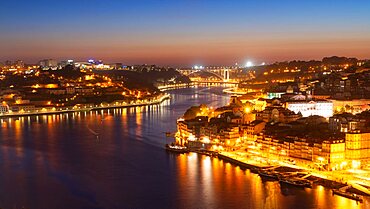 Skyline of the historic city of Porto at night. In the background the bridge Ponte de Arrabida. Portugal, Europe