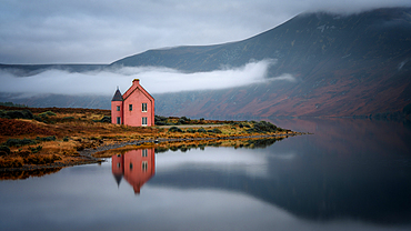 Abandoned pink house on Loch Glass, Highlands, Scotland, United Kingdom