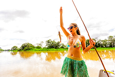 Woman showing her freshly caught fish from the Amazon River, Peru, South America