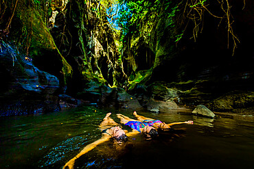 Women floating peacefully in the water at the Beji Guwang Hidden Canyon, Bali, Indonesia, Southeast Asia, Asia