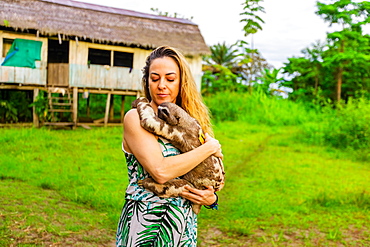 Visitor holding a local Sloth, Peru, South America