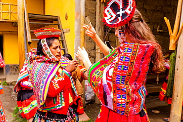 Visitors learning how to weave from the Huilloc weavers, Peru, South America