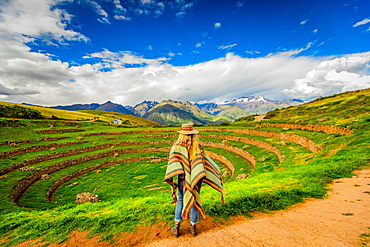 Woman looking out at Inca ruins, Moray, Peru, South America