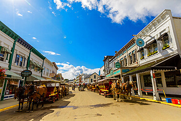 Horse and carriage filled streets lined with beautiful colorful buildings, Mackinac Island, Michigan, United States of America, North America