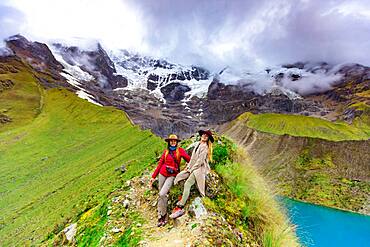 Two women trekking Humantay Lake, Cusco, Peru, South America