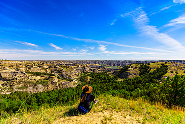 Woman enjoying the view along the Theodore Roosevelt National Park North Unit, North Dakota, United States of America, North America