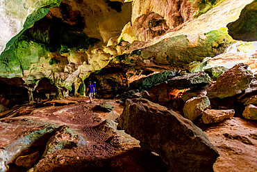 Man exploring sea caves on North Caicos, Turks and Caicos Islands, Atlantic, Central America