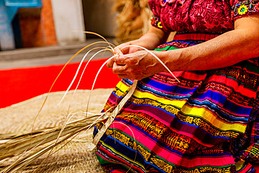 K'iche artisans weaving straw hats, Guatemala, Central America