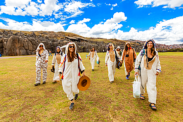 Women dressed in alpaca llama onesies in Cusco, Peru, South America