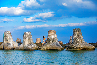 Woman on tetrapods on Yonaguni Island, Yaeyama Islands, Japan, Asia