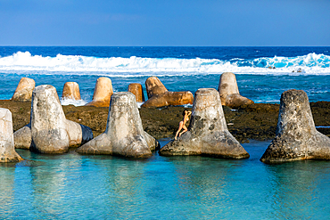 Woman on tetrapods on Yonaguni Island, Yaeyama Islands, Japan, Asia