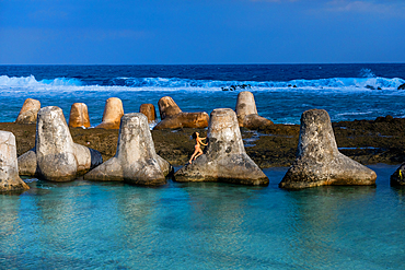 Woman on tetrapods on Yonaguni Island, Yaeyama Islands, Japan, Asia