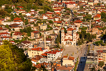 Aerial view of Berat, Albania, featuring the Orthodox Church of Saint Demetrius in the city center. The historic town, a UNESCO World Heritage site, is known for its red-tiled roofs, Ottoman-era architecture, and surrounding mountain scenery.