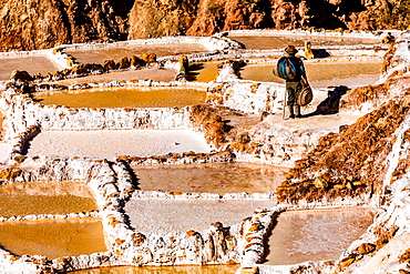 Salt terraces in the Sacred Valley where people are still mining and sifting the terraced pools as the Incas did 1000 years ago, Peru, South America