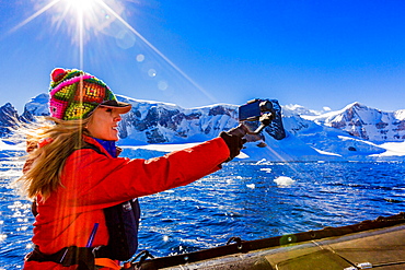 Documenting the scenic view of the glacial ice and floating icebergs in Antarctica, Polar Regions