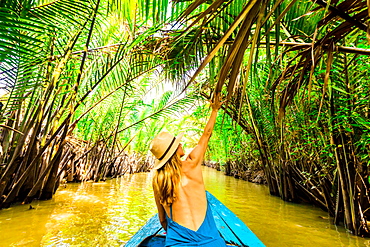 Sailing the tributaries of the Mekong River to get to a village to see how coconut candy is made, Vietnam, Indochina, Southeast Asia, Asia