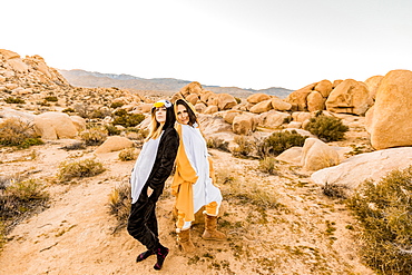 Two friends in spirit animal onesies celebrating the new year in Joshua Tree, California, United States of America, North America