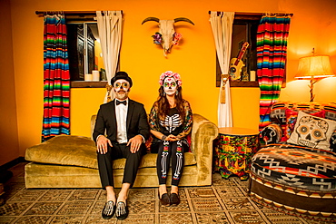 Man and woman in Dia de los Muertos makeup and costume, Day of the Dead celebration in the desert, California, United States of America, North America