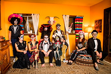 Group of friends in Dia de los Muertos makeup and costume, Day of the Dead celebration in the desert, California, United States of America, North America