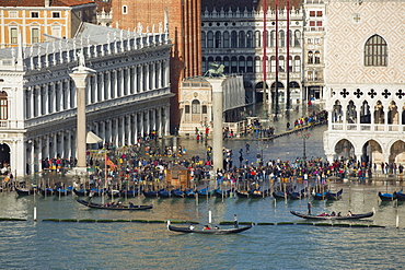 Elevated view of a busy St. Mark's Square in Venice during high tide with gondolas lined up along the shore, Venice, UNESCO World Heritage Site, Veneto, Italy, Europe