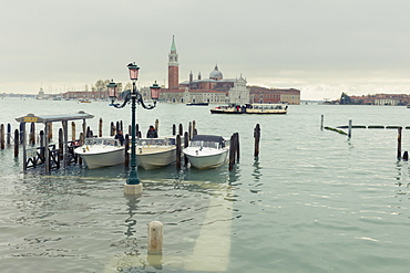 Water taxis moored beside a submerged walkway on the shores of St. Mark's Basin after the highest tide in Venice since 1966, Venice, UNESCO World Heritage Site, Veneto, Italy, Europe