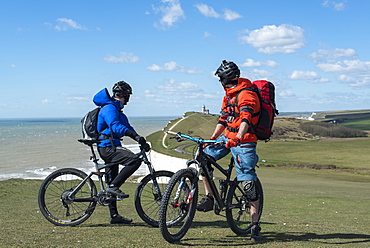 Mountain biking along the chalk cliffs coastal path on the South Downs Way near Beachy Head, South Downs National Park, East Sussex, England, United Kingdom, Europe