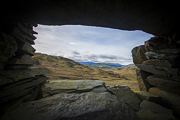 Looking through a window of a crumbling stone house on Place Fell in the English Lake District, Lake District National Park, Cumbria, England, United Kingdom, Europe