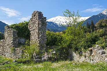 The ancient ruins of Mystras, UNESCO World Heritage Site, and the snow covered Taygetos Mountains in the distance, Peloponnese, Greece, Europe