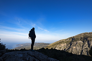 A woman hiking in the Taygetos Mountains on the Mani Peninsula in the Peloponnese, Greece, Europe