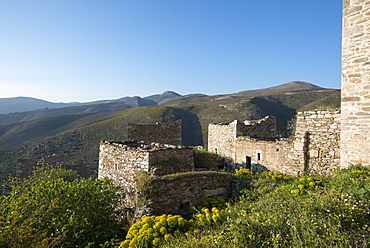 The ancient towers of Vathia among wild spring flowers on the Mani Peninsula in the Peloponnese, Greece, Europe