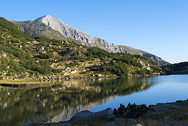 Hiking around Ribno Lake with  Vihren peak distant, the highest point in the Pirin mountains, Bulgaria, Europe