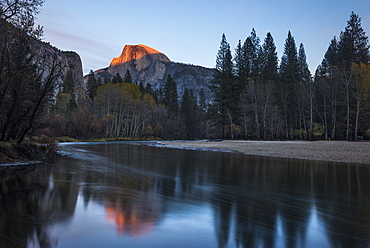 Half Dome mountain catches the last glow of sunset reflected in the Merced river in Yosemite National Park, UNESCO World Heritage Site, California, United States of America, North America