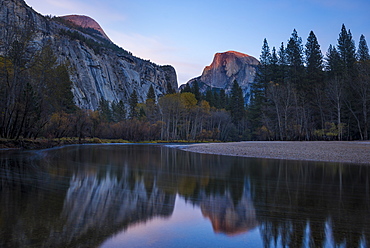 Half Dome mountain catches the last glow of sunset reflected in the Merced River in Yosemite National Park, UNESCO World Heritage Site, California, United States of America, North America