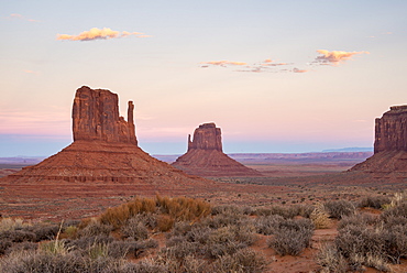 The giant sandstone buttes glowing pink at sunset in Monument Valley Navajo Tribal Park, Arizona, United States of America, North America