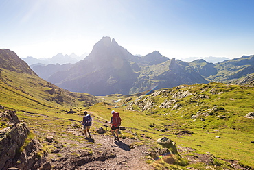 Walkers descend from the top of Col d'Ayous on the GR10 trekking route in the French Pyrenees, Pyrenees Atlantiques, France, Europe