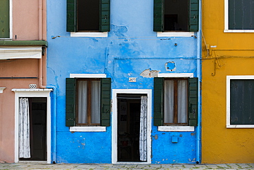 Exterior facades, doors and windows of colourful buildings and walls on the island of Burano, Venice, Veneto, Italy, Europe