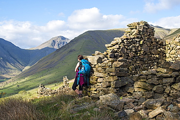 Crumbling stone houses in the English Lake District in Wast Water with views of Kirk Fell and Great Gable in the distance, Lake District National Park, Cumbria, England, United Kingdom, Europe