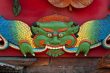 A vibrantly painted deity on display in the historical Newar city of Bhaktapur, Nepal, Asia