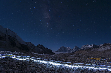 Departure of the Sherpas, their head-torches leaving trails of light across the glacier on their way to Everest, Nepal, Himalayas, Asia