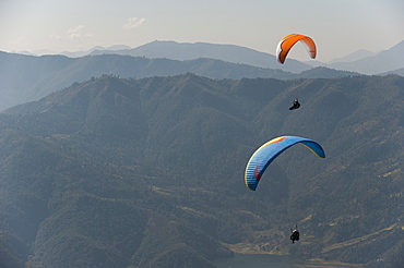 Paragliders flying above Pokhara, Nepal, Himalayas, Asia