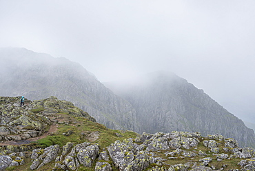 Walking through Crinkle Craggs at the head of the Great Langdale valley on a misty day, Lake District National Park, Cumbria, England, United Kingdom, Europe