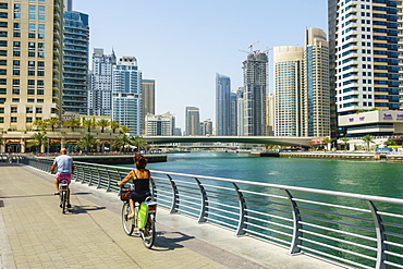 Cyclists on Marina Walk, Dubai Marina, Dubai, United Arab Emirates, Middle East